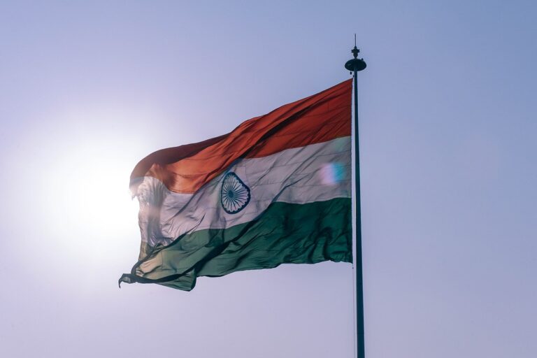 The India flag waving in the breeze over a sunlit sky